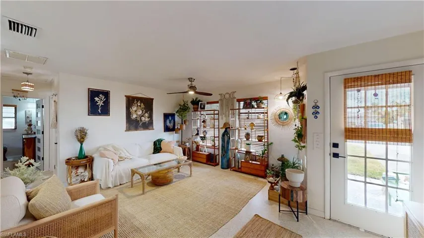 Living room with ceiling fan and plenty of natural light