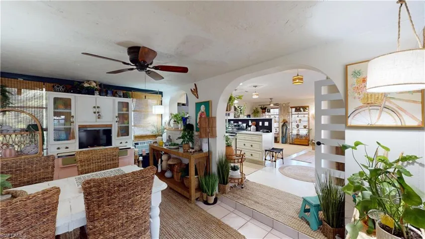Tiled dining room featuring a textured ceiling and ceiling fan