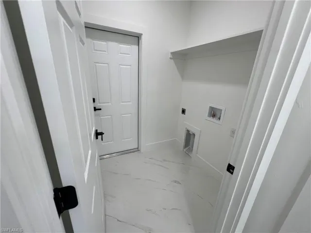 Washroom with washer hookup, electric dryer hookup, and light tile patterned floors