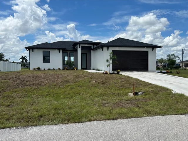 Prairie-style house featuring a garage and a front yard