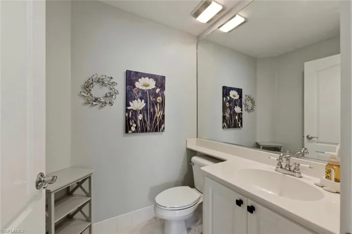 Half bath featuring vanity and light tile patterned flooring