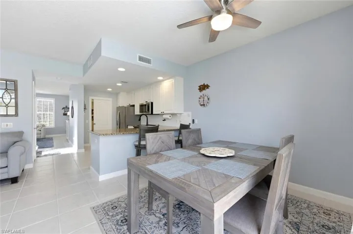 Dining space with a ceiling fan, light tile patterned floors, and recessed lighting