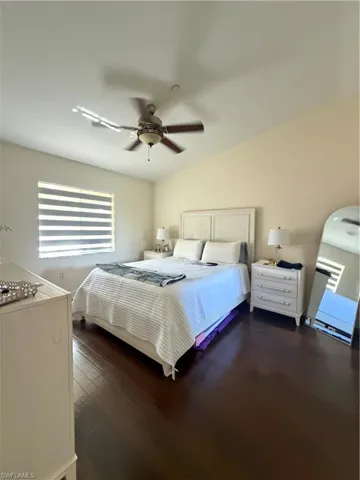 Bedroom with dark wood-type flooring and ceiling fan