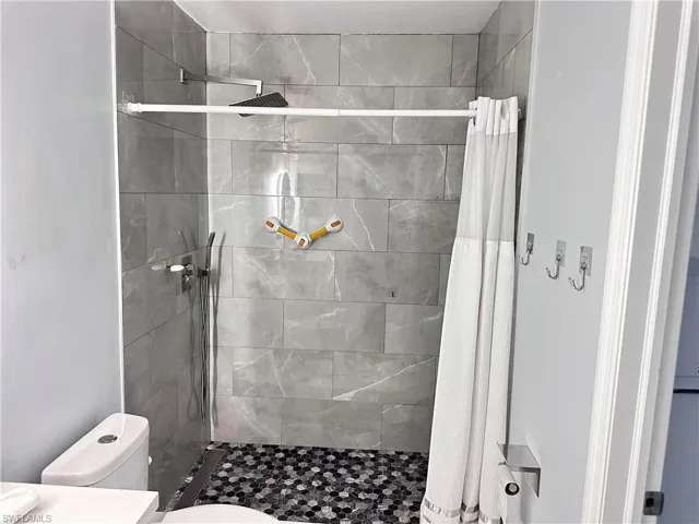Full bathroom with a shower stall and vanity
