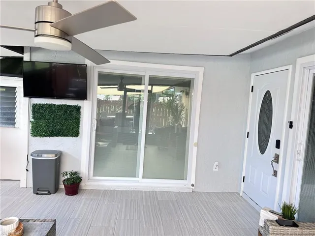 Doorway to property featuring stucco siding