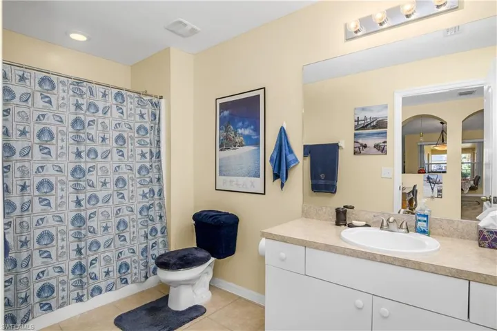 Bathroom featuring visible vents, toilet, vanity, baseboards, and tile patterned floors