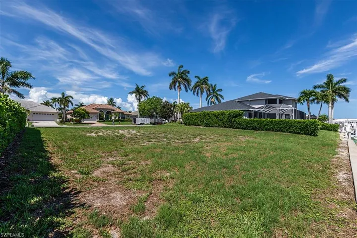 View of grassy yard with a garage