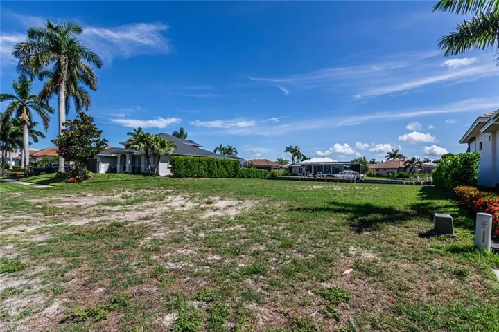 View of green lawn with a residential view