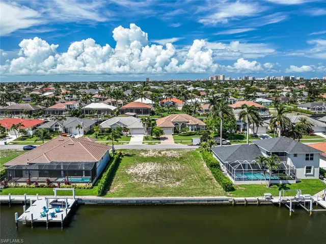 Aerial perspective of suburban area with a nearby body of water