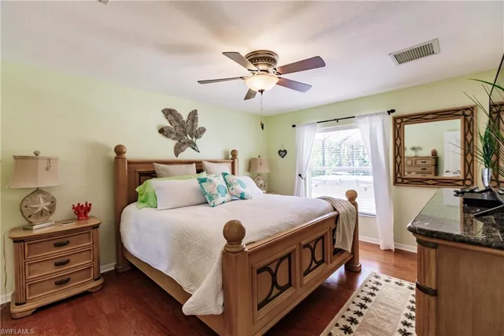 Bedroom featuring dark hardwood / wood-style flooring and ceiling fan