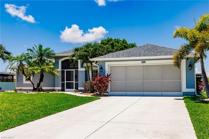 View of front of property with a front lawn and a garage