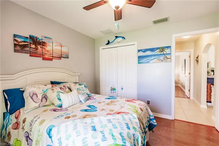 Tiled bedroom featuring a closet and ceiling fan
