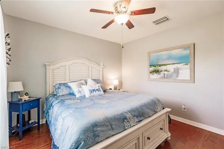 Bedroom featuring ceiling fan and dark hardwood / wood-style flooring