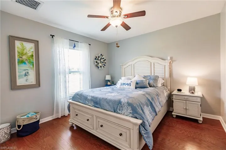 Bedroom with dark wood-type flooring and ceiling fan