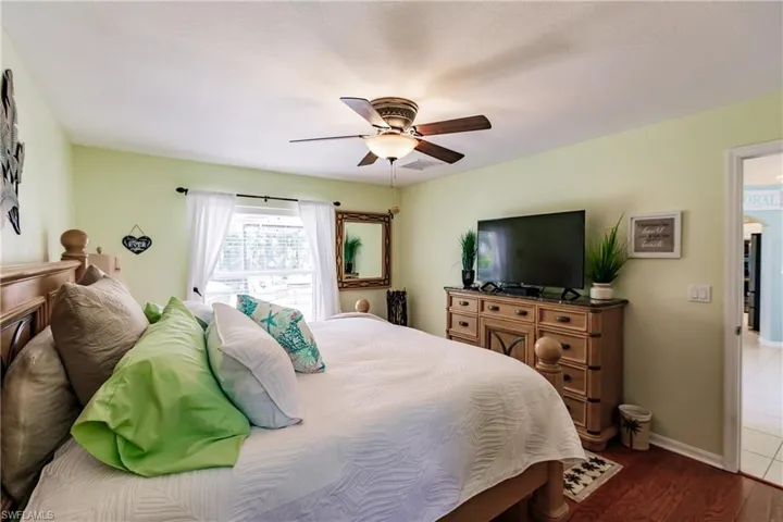Bedroom featuring wood-type flooring and ceiling fan