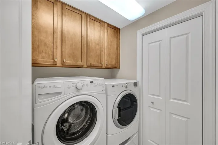 Full-size laundry with large storage closet.