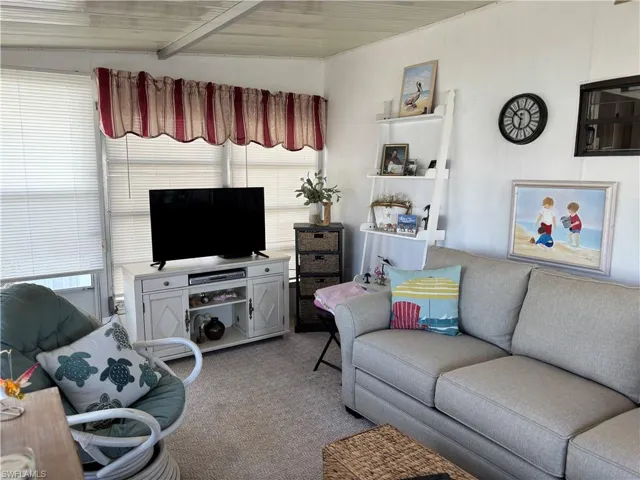Living area featuring light carpet