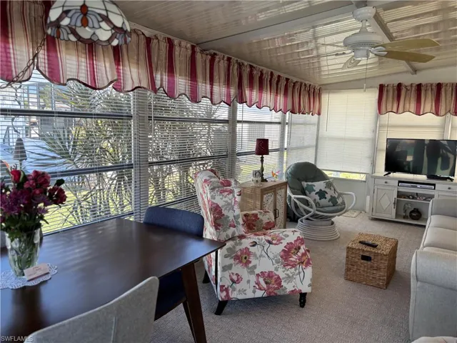 Sunroom / solarium featuring carpet floors and healthy amount of natural light