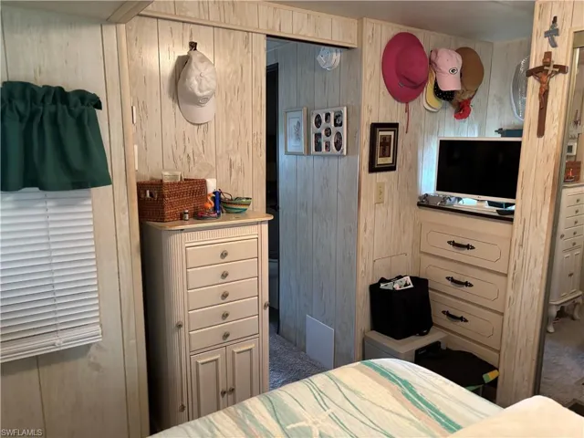 Bedroom featuring wooden walls