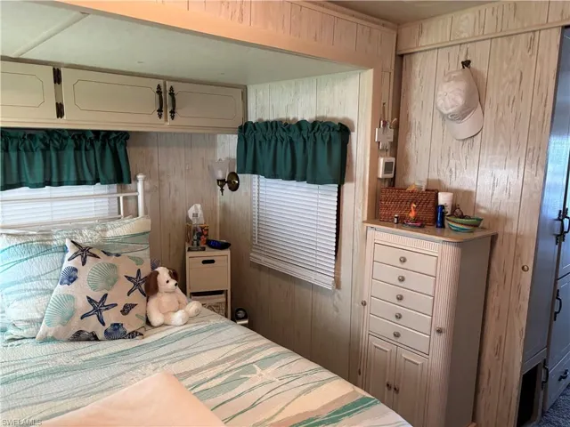 Bedroom with wood walls
