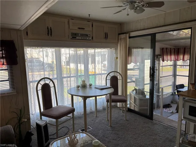 Sunroom / solarium featuring carpet floors and plenty of natural light