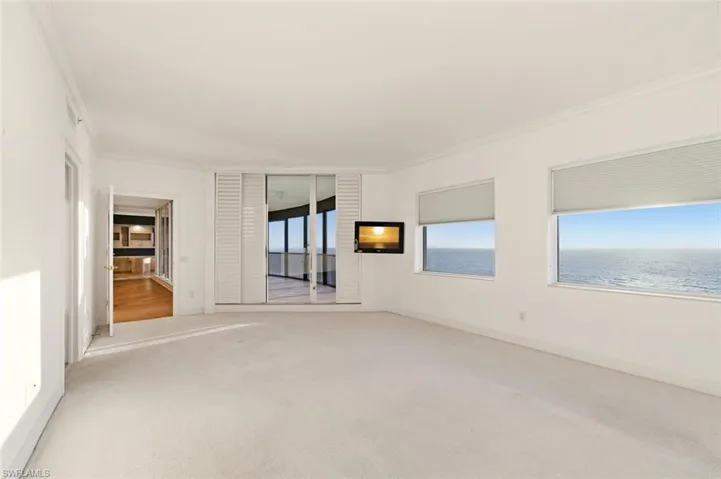 Unfurnished room featuring ornamental molding and carpet flooring