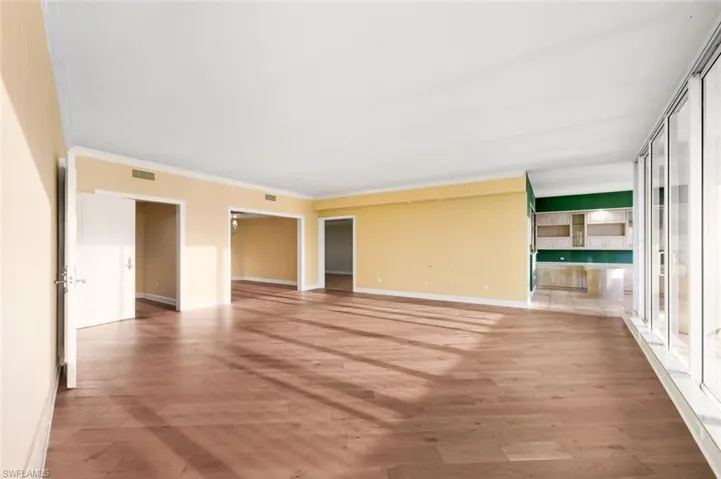 Unfurnished room with light wood finished floors and crown molding
