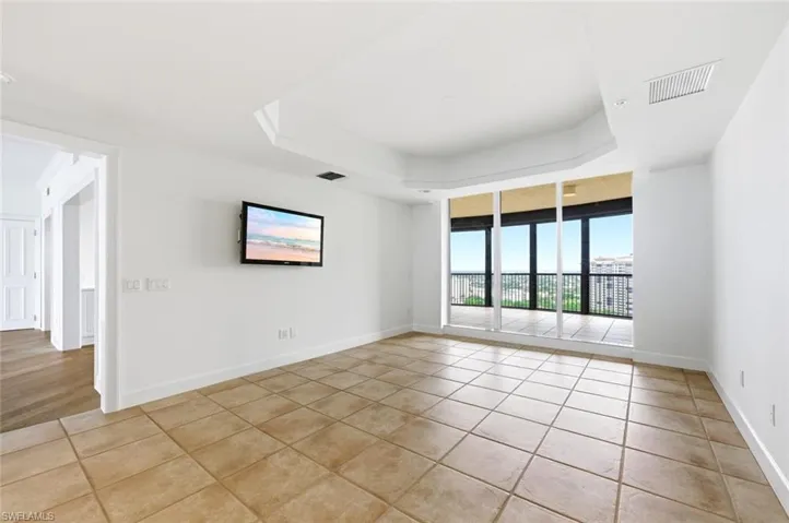 White cabinetry kitchen featuring speckled countertops, stainless steel appliances, recessed lighting, and tile flooring