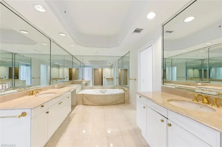 Pedestal sink with brass-finish faucet fixtures and coordinating towel bar