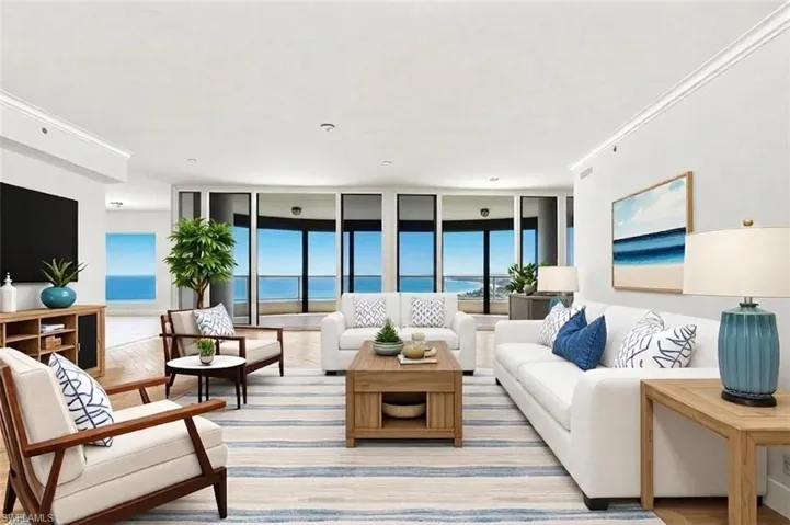 Spacious living area featuring expansive windows, wood-finish flooring, recessed lighting, crown molding, and a built-in entertainment console