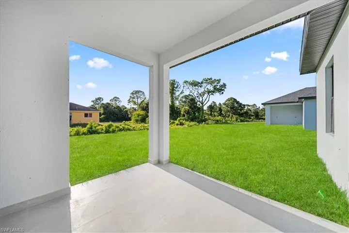 Covered patio with a smooth concrete floor, providing an expansive outdoor living area