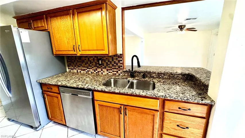 Stainless steel appliances and granite countertops, real wood cabinets