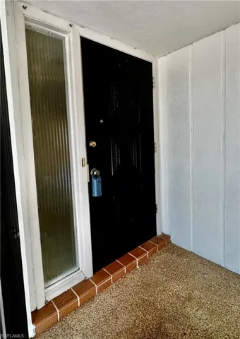 Screened in front vestibule.  Ornate solid wood front door                                g