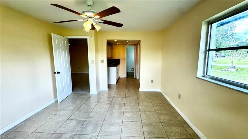 Ceiling fans in all the bedrooms. View into primary bathroom
