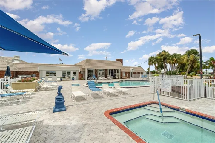View of swimming pool featuring a patio and a hot tub