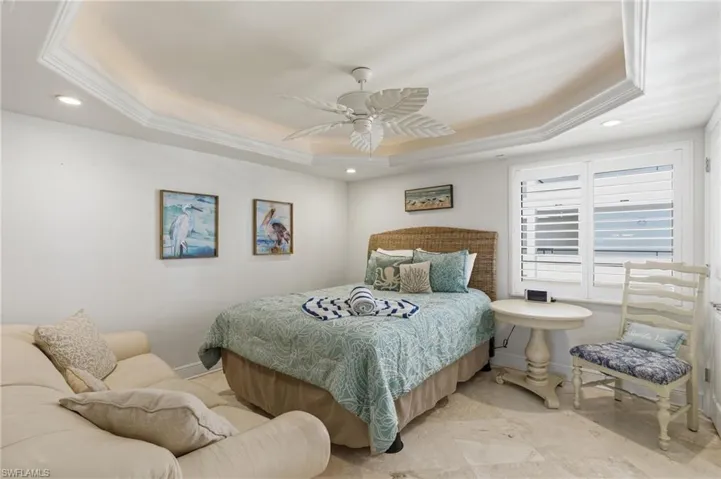 Guest Bedroom with tray ceiling and spacious enough for sitting couch.  Photo may be digitally enhanced.