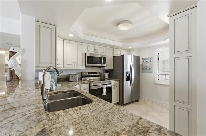 Beautiful granite counters, stainless steel appliances, and beautiful cabinetry.  Gorgeous tile through out the condo.  Photo Digitally Enhanced