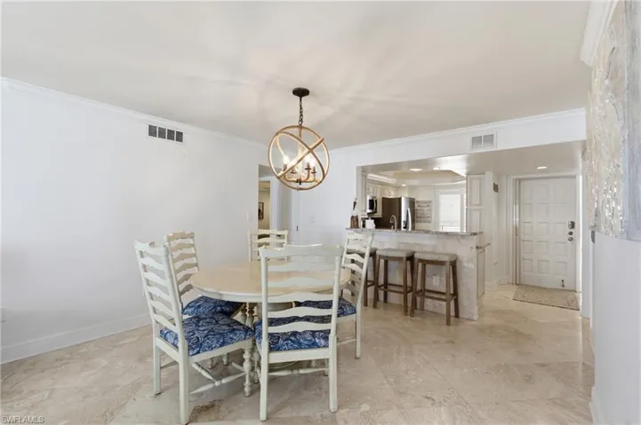 Dining table just off the kitchen with seating for five.  Photo Digitally Enhanced