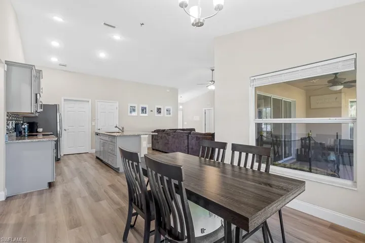 Dining area with ceiling fan, visible vents, and light wood finished floors