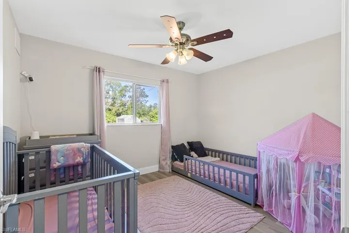 Bedroom with baseboards, ceiling fan, and wood finished floors