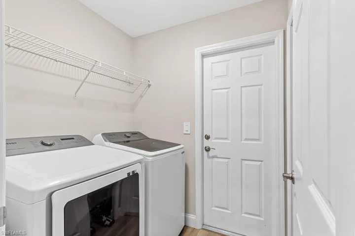 Washroom featuring washing machine and dryer and laundry area