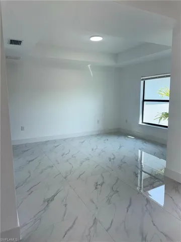 Spare room featuring recessed lighting and light marble finish floors