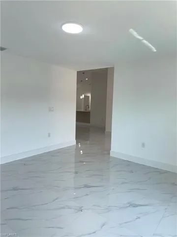 Empty room with baseboards and light marble finish flooring