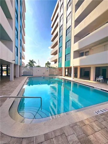 Community pool featuring a patio