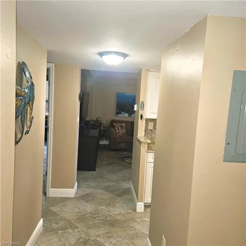 Corridor with electric panel and a textured wall