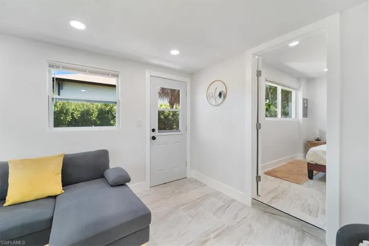 Foyer entrance with recessed lighting, marble finish floor, and baseboards