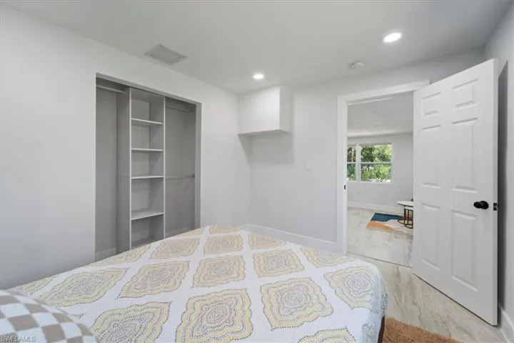 Bedroom with recessed lighting, light wood-style floors, a closet, visible vents, and baseboards
