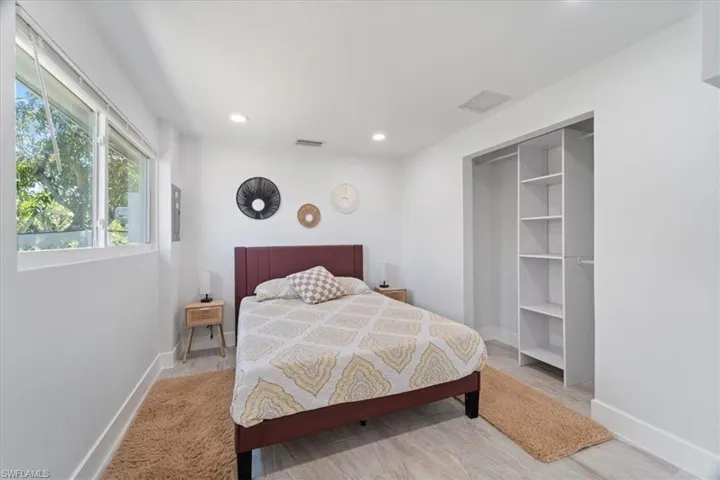 Bedroom with baseboards, visible vents, and recessed lighting