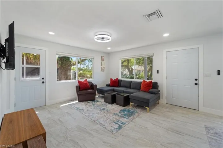 Living area featuring recessed lighting, visible vents, and baseboards