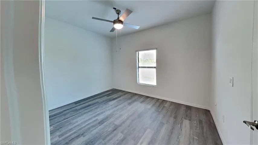 Unfurnished room with wood finished floors and ceiling fan